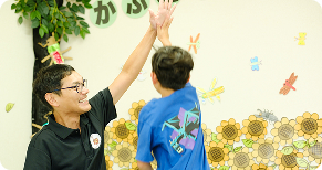 作業療法士が子供と遊んでいるシーン